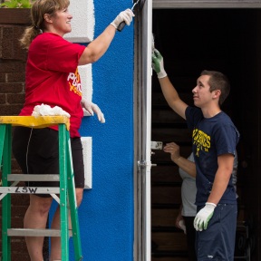 Kathy Kane (left), of the Rotary Club of Trenton, and her son, Interactor Dustin Kane, paint Irma Fuentes' hardware store in Detroit, Michigan, USA, 26 July 2014. Rotarians from Detroit area clubs donated money and labor to assist with these improvements. Fuentes is one of 13 participants in the inaugural LaunchDETROIT program. LaunchDETROIT, a project of Rotary District 6400, offers entrepreneurs and small business owners in the Detroit area free business training, microloans, business mentoring, and networking opportunities.
